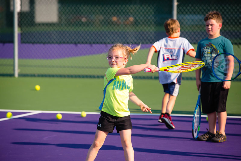 children learning tennis